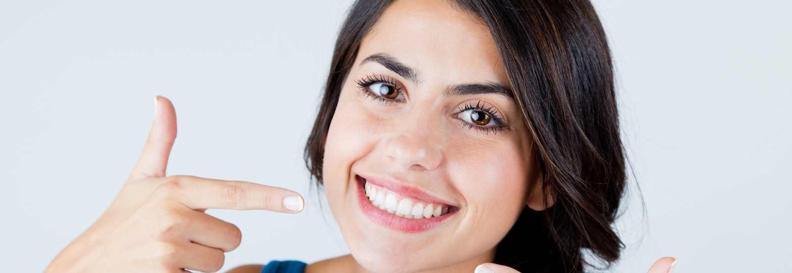 A woman pointing at her teeth